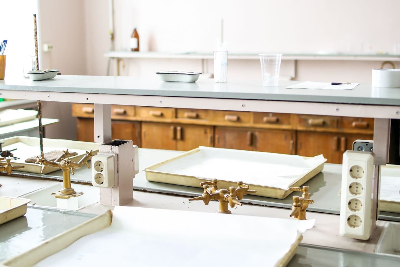 An empty laboratory bench with trays and taps