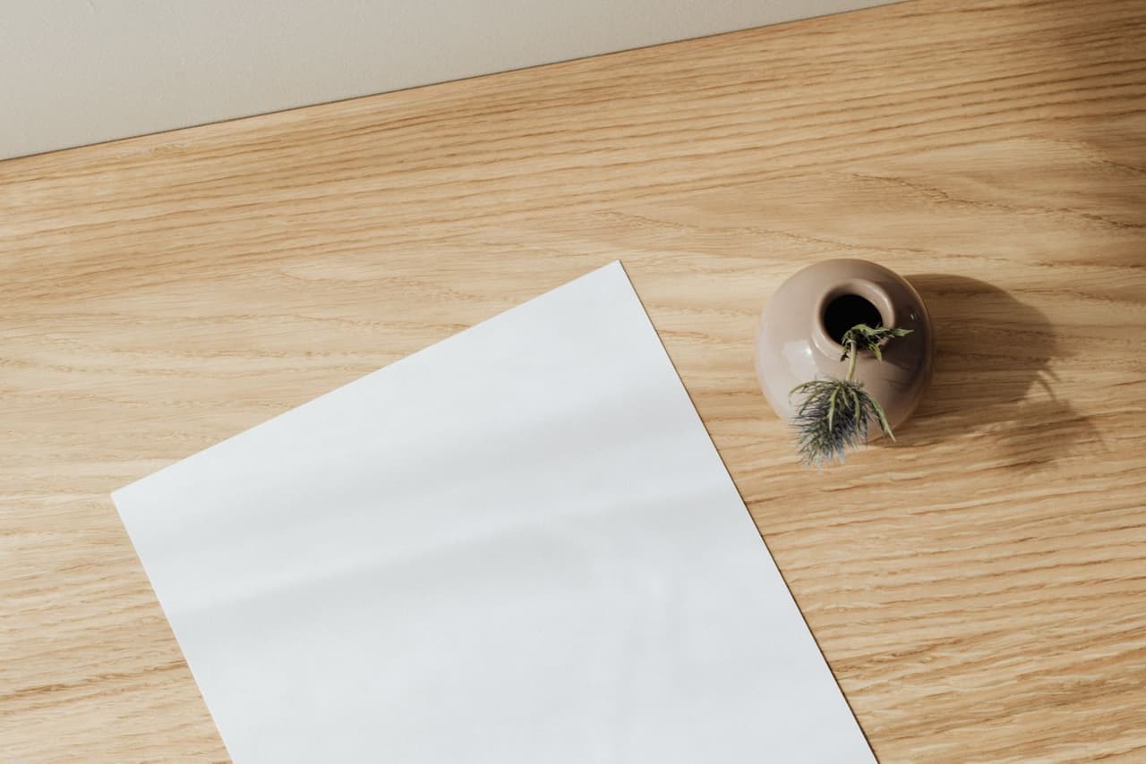 A blank sheet of paper on a wooden table